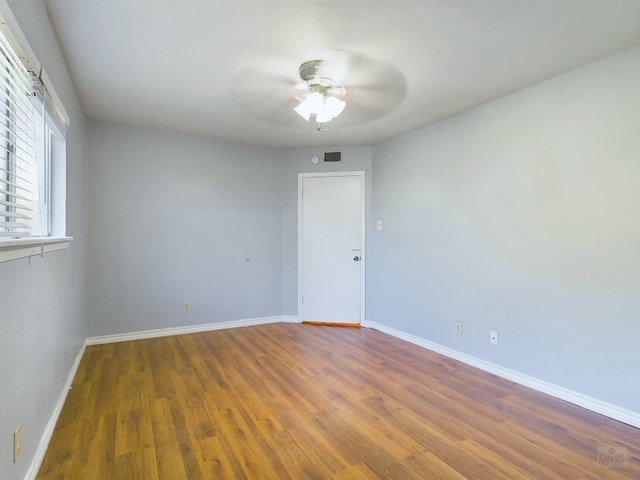 spare room with ceiling fan and dark hardwood / wood-style flooring