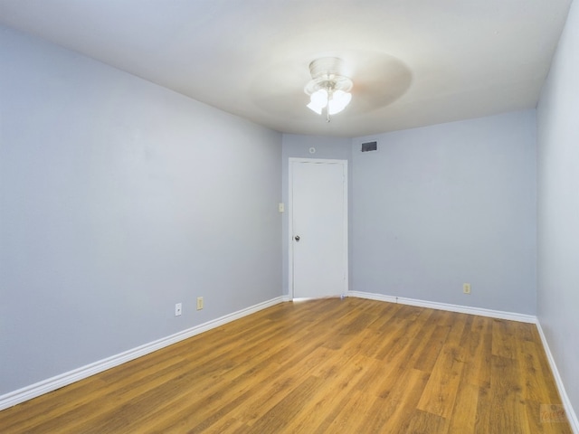 spare room featuring hardwood / wood-style flooring and ceiling fan