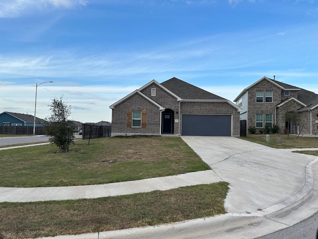 view of front facade featuring a front yard and a garage