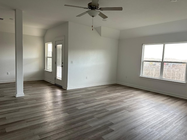 empty room with dark hardwood / wood-style floors, ceiling fan, and lofted ceiling