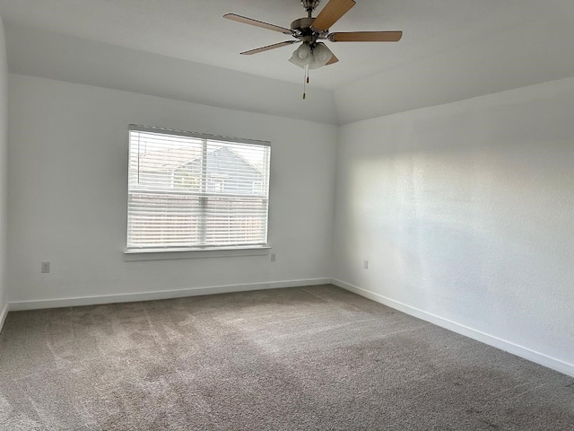 unfurnished room featuring carpet floors, vaulted ceiling, and ceiling fan