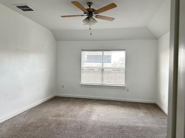 unfurnished room with ceiling fan, carpet floors, and vaulted ceiling