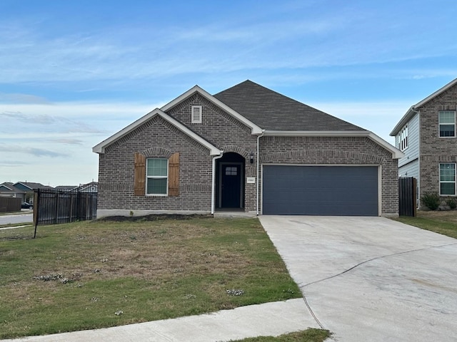 view of front of property featuring a garage and a front lawn