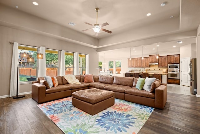 living room featuring ceiling fan and wood-type flooring