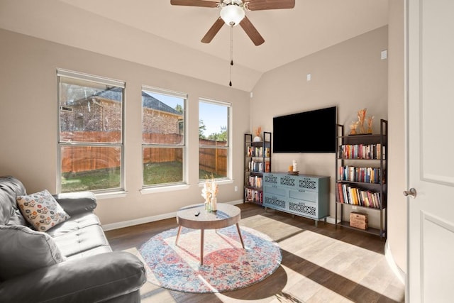 living room featuring dark hardwood / wood-style floors, ceiling fan, and lofted ceiling