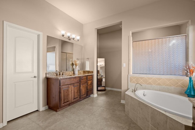 bathroom with tile patterned floors, vanity, and shower with separate bathtub