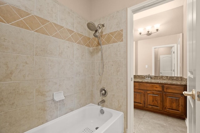 bathroom with tile patterned floors, vanity, and tiled shower / bath