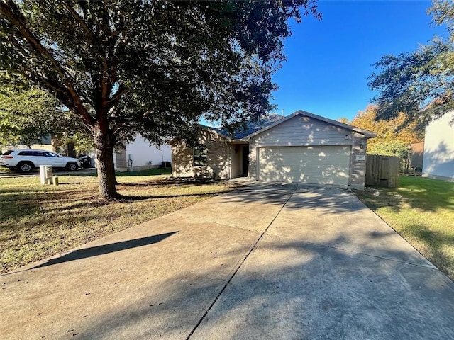 ranch-style home with a front lawn and a garage