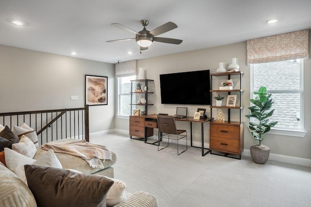 home office featuring ceiling fan and light carpet