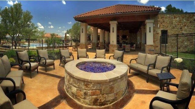 view of patio with a gazebo and an outdoor living space with a fire pit