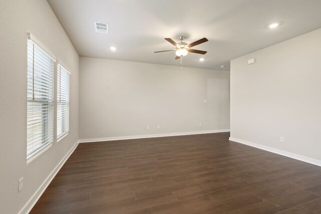 spare room featuring ceiling fan, dark wood finished floors, baseboards, and recessed lighting