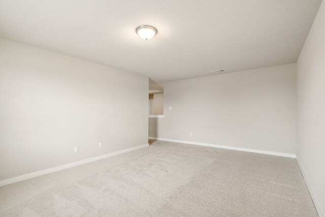carpeted spare room with baseboards