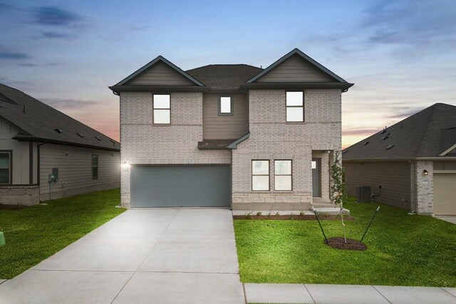 view of front facade with brick siding, a garage, concrete driveway, central AC unit, and a front lawn