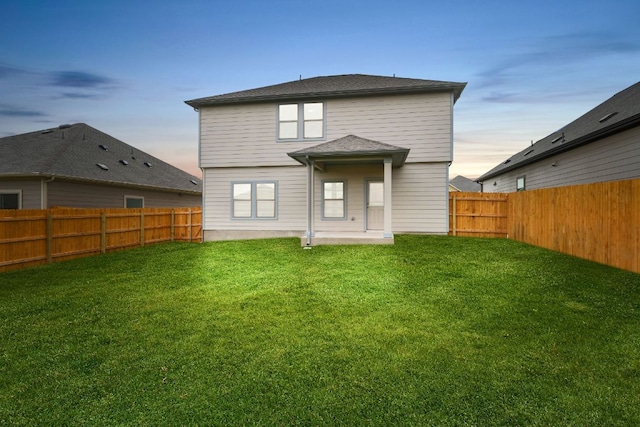 245 Little Green Trl, Jarrell, TX 76537 - back of house at dusk with a fenced backyard
