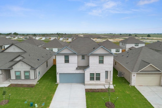 245 Little Green Trl, Jarrell, TX 76537 - view of front of property featuring driveway, a residential view, brick siding, and a front lawn