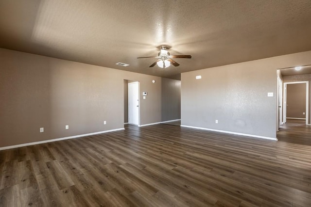 spare room featuring a textured ceiling, ceiling fan, and dark hardwood / wood-style floors