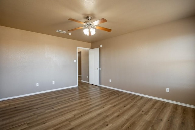 spare room with ceiling fan and dark hardwood / wood-style flooring