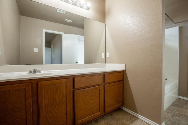 bathroom with tile patterned flooring and vanity