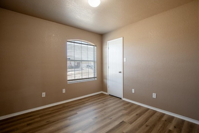 spare room with wood-type flooring