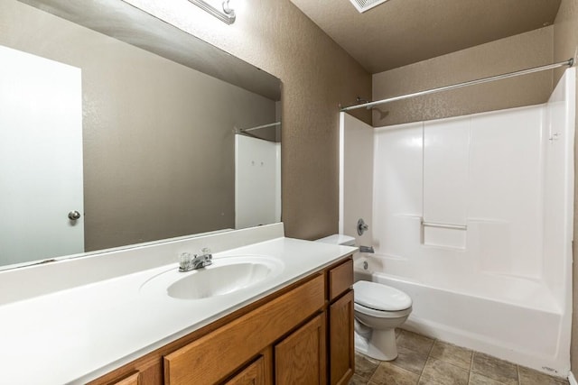 full bathroom featuring shower / washtub combination, vanity, a textured ceiling, and toilet