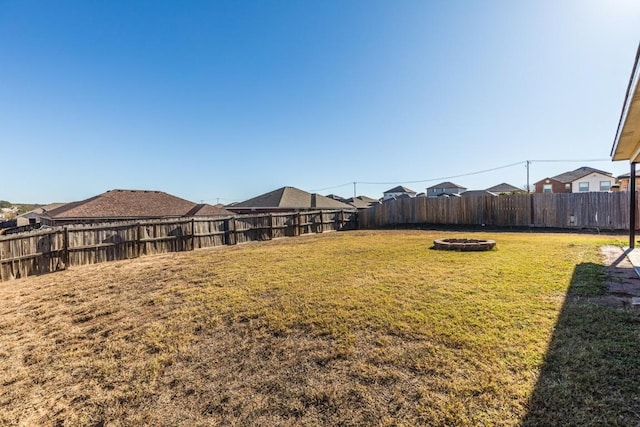 view of yard with a fire pit