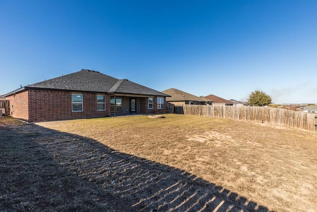 rear view of house with a yard