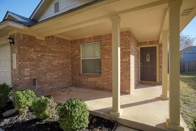 exterior space with a porch and a garage