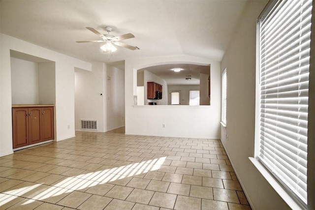 tiled spare room with ceiling fan and lofted ceiling