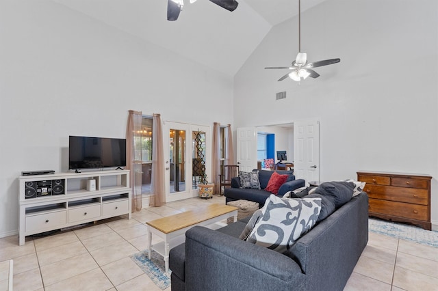 tiled living room featuring ceiling fan and high vaulted ceiling