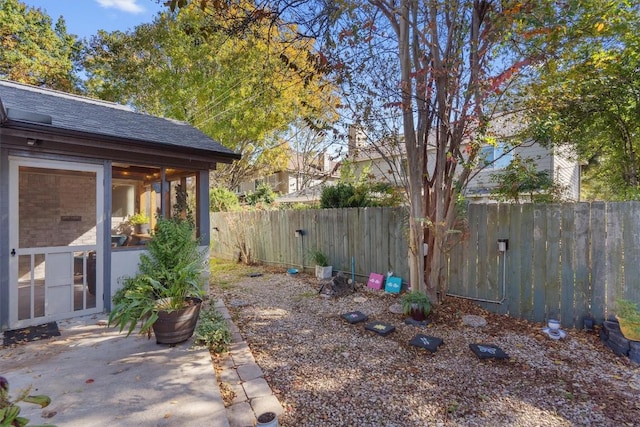 view of yard featuring a sunroom and a patio area