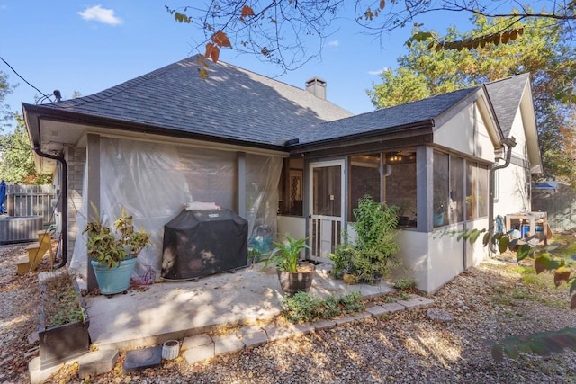 back of house with central AC, a patio area, and a sunroom