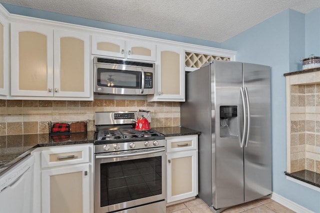 kitchen with white cabinetry, appliances with stainless steel finishes, and tasteful backsplash