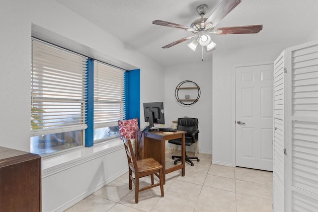 office space featuring ceiling fan, light tile patterned floors, and a textured ceiling