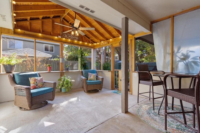 sunroom featuring vaulted ceiling with beams and ceiling fan