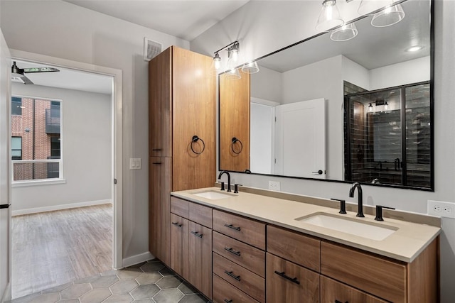 bathroom featuring walk in shower, vanity, and hardwood / wood-style flooring