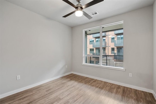 unfurnished room with ceiling fan and light wood-type flooring