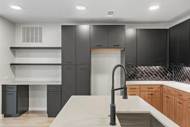 kitchen featuring light wood-type flooring and tasteful backsplash