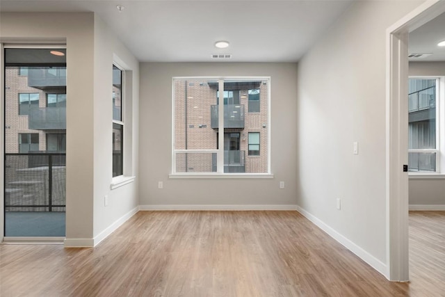 spare room featuring light wood-type flooring