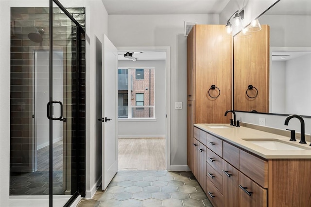 bathroom with vanity, tile patterned floors, ceiling fan, and a shower with shower door