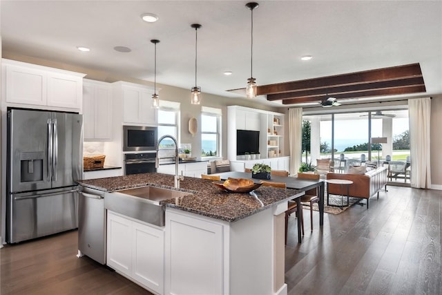 kitchen featuring a wealth of natural light, white cabinetry, sink, and stainless steel appliances