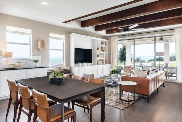 living room featuring beamed ceiling, dark hardwood / wood-style flooring, and ceiling fan