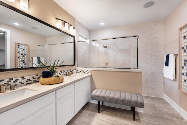 bathroom with backsplash, vanity, wood-type flooring, and tiled shower