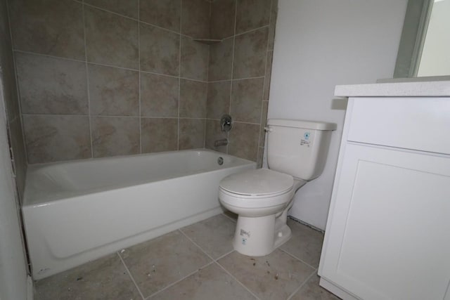 full bathroom featuring tile patterned floors, vanity, toilet, and tiled shower / bath