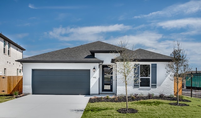 single story home featuring a shingled roof, fence, concrete driveway, a front yard, and an attached garage