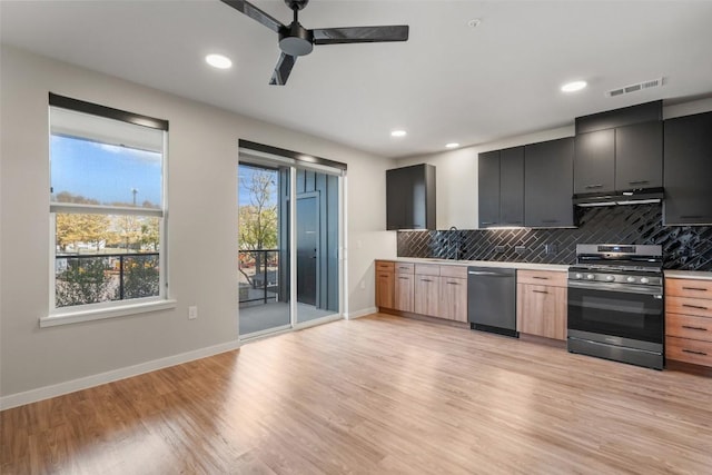 kitchen with ceiling fan, tasteful backsplash, light wood-type flooring, light brown cabinetry, and appliances with stainless steel finishes