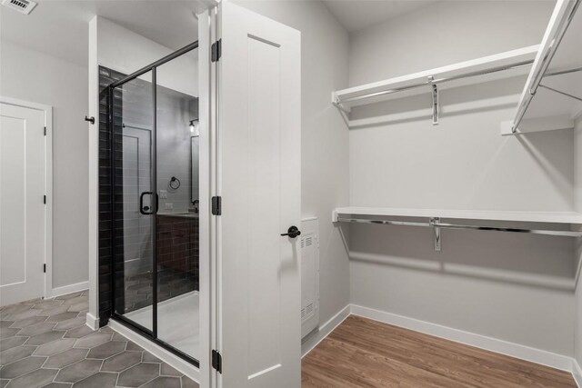 bathroom featuring hardwood / wood-style flooring and a shower with door