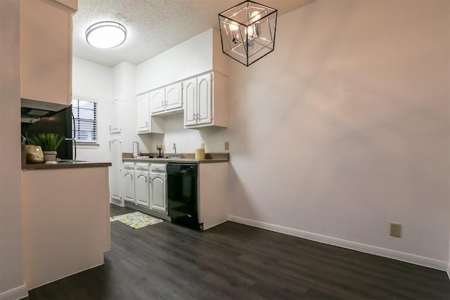 kitchen with dishwasher, dark hardwood / wood-style flooring, white cabinets, and hanging light fixtures