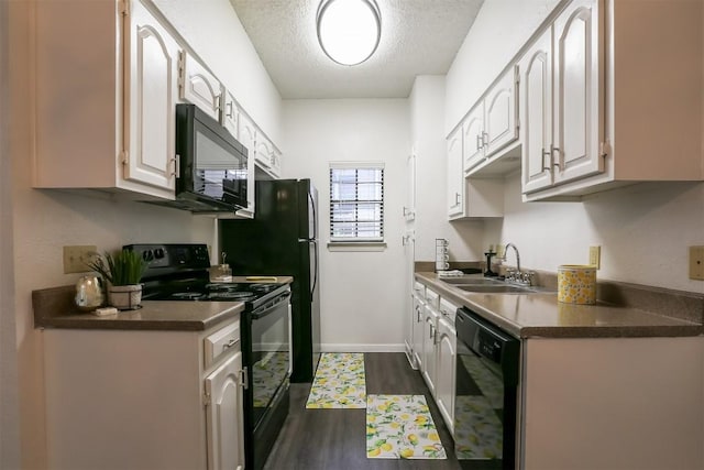 kitchen with sink, dark wood-type flooring, a textured ceiling, white cabinets, and black appliances