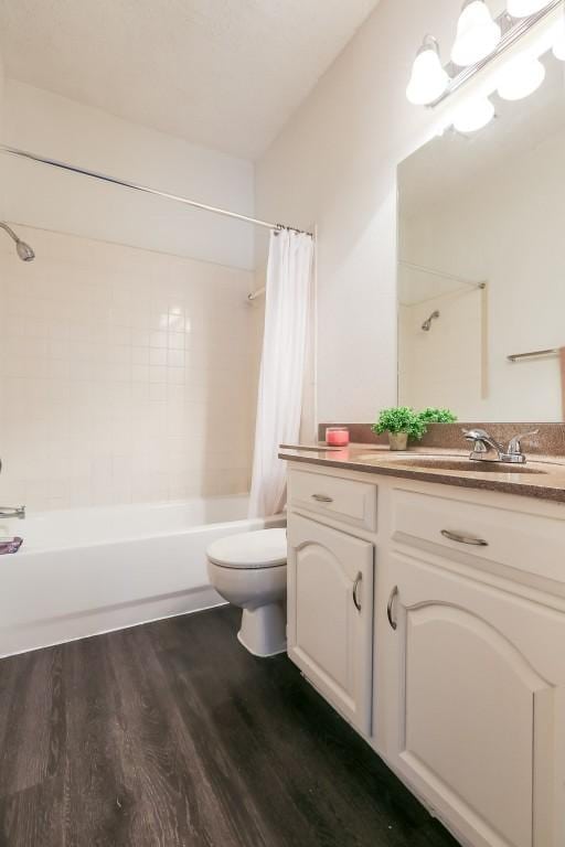 full bathroom featuring hardwood / wood-style flooring, vanity, toilet, and shower / bathtub combination with curtain