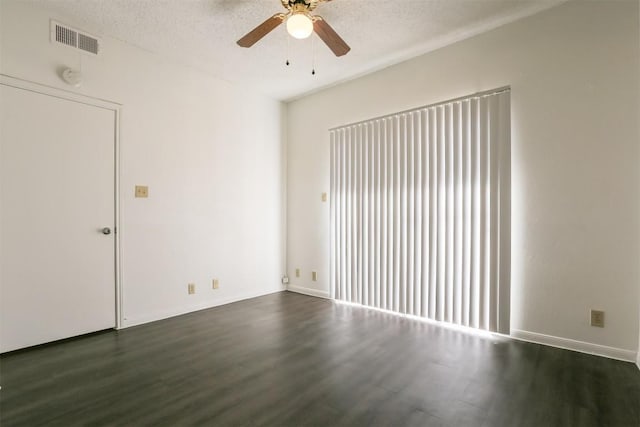 spare room featuring a textured ceiling, dark hardwood / wood-style floors, and ceiling fan